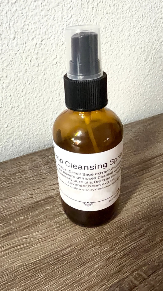 Bottle of 'Cleansing Spray' on a wooden surface with a white background
